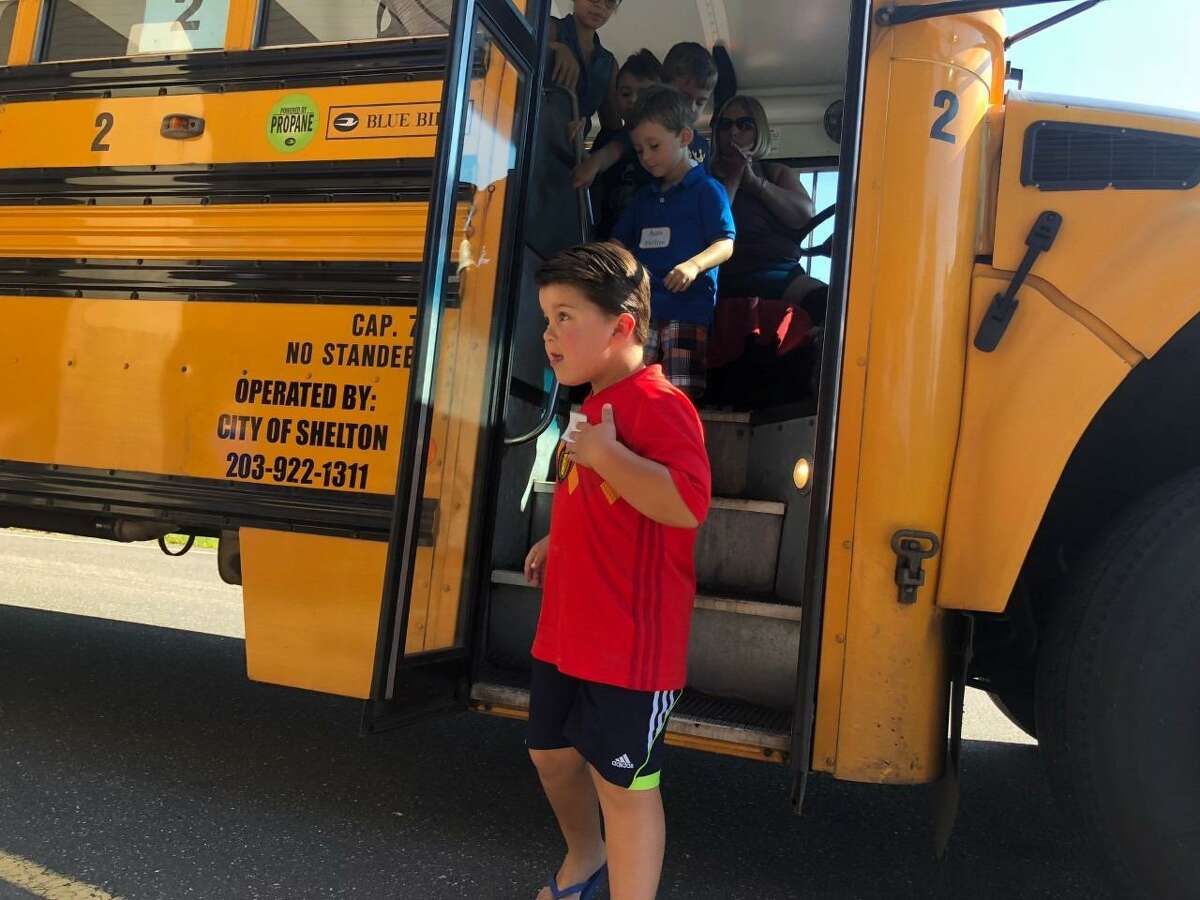 Incoming kindergartners get off the bus after going for a trial run on the morning of Friday, Aug. 30, at Elizabeth Shelton School.
