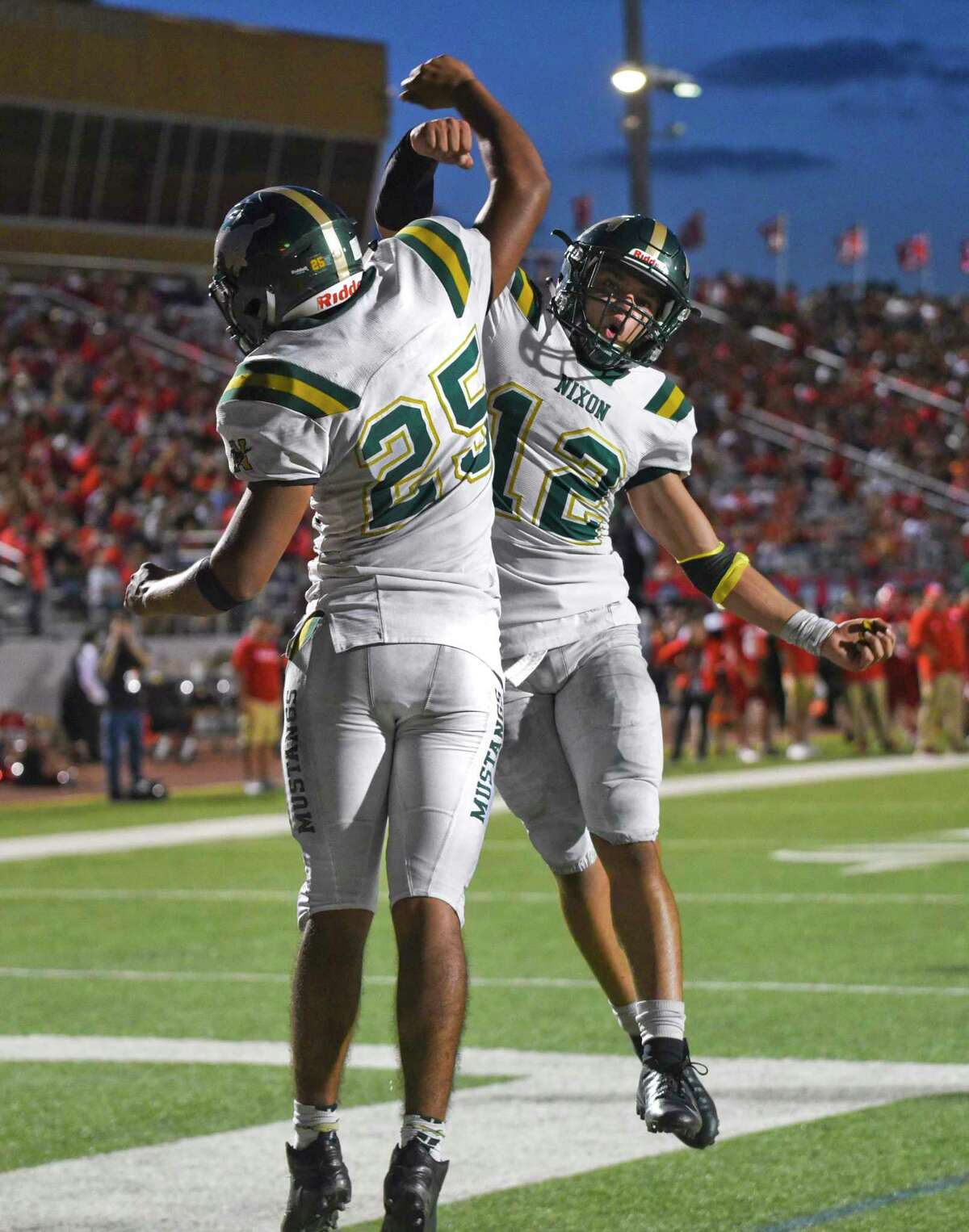 Pablo Tovar and Joseph Ibarra celebrate a touchdown Friday in Nixon’s 33-30 win over rival Martin at Shirley Field.