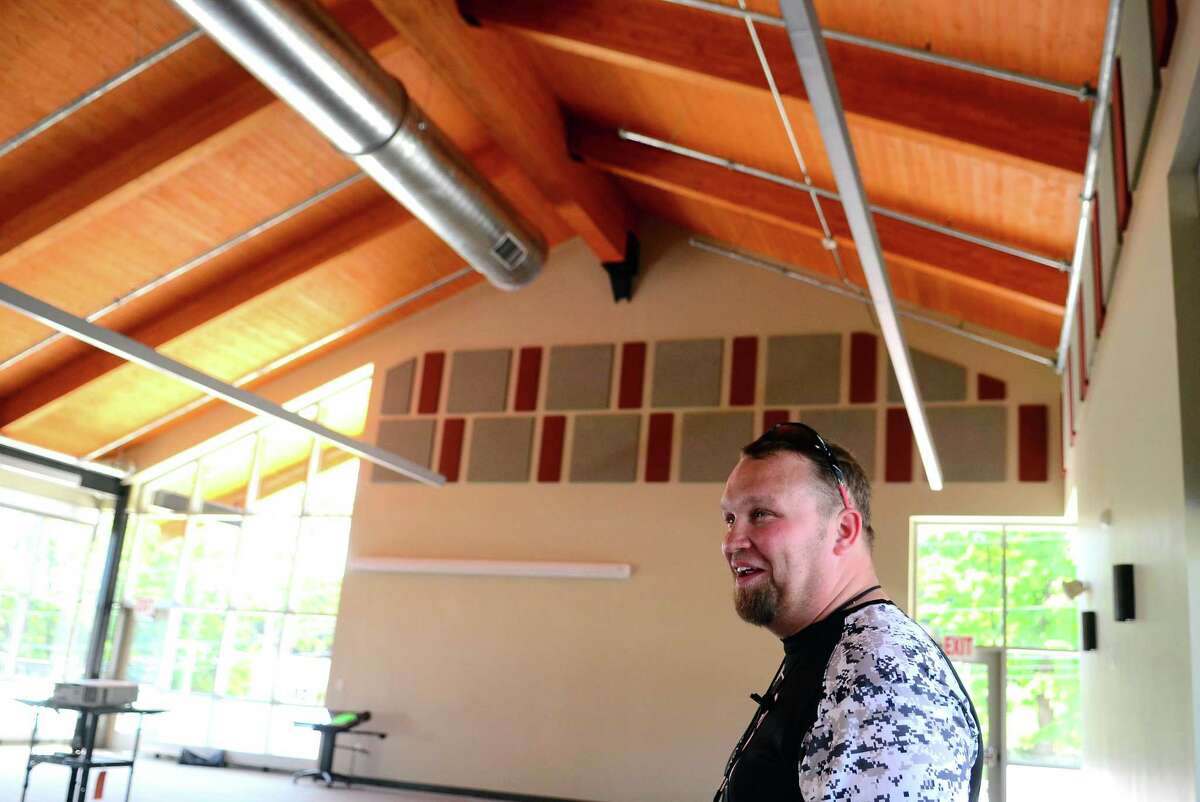 Derby High School football coach Goerge French gives a tour of the new J.R. Payden Field House in Derby on Friday.