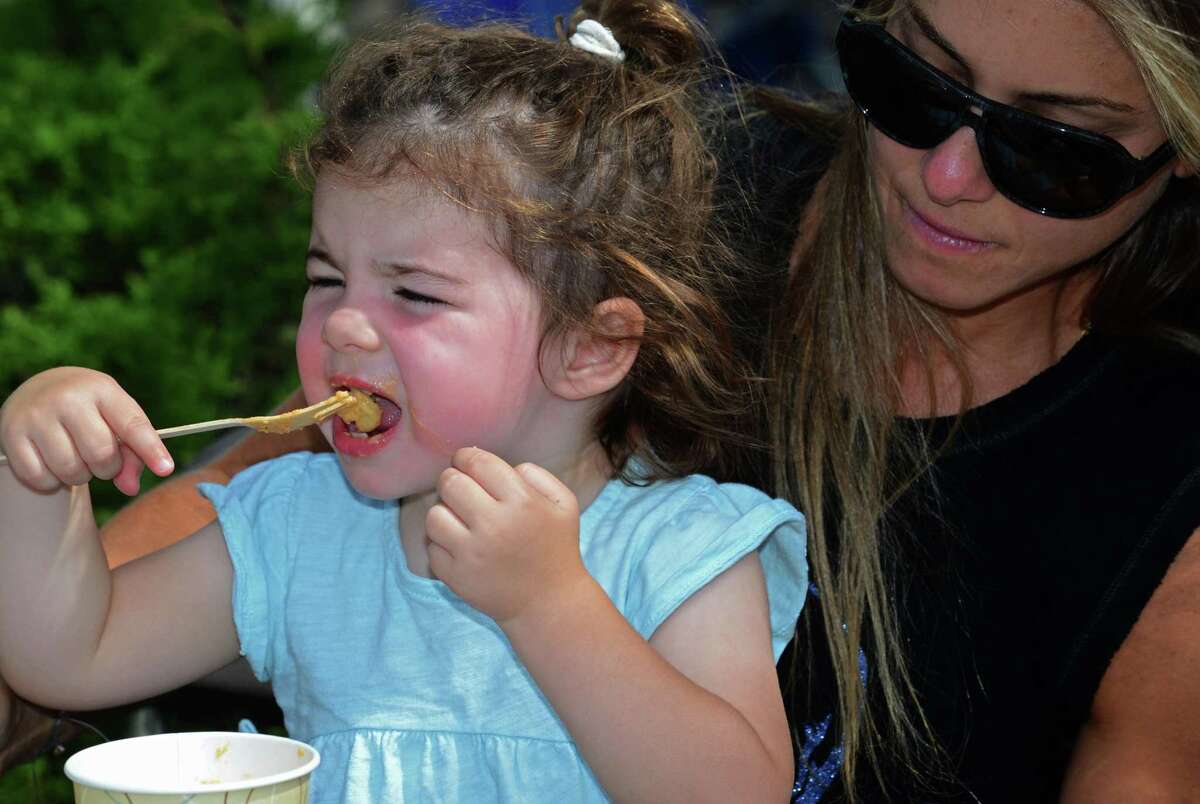 Triciia Large and her daughter Charlie Large, 2, of Norwalk enjoy Mac & Cheese during The 12th annual Blues & Views Festival Saturday, August 31, 2019, at the Levitt Pavillion in Westport, Conn. A Fairfield County tradition since 2008, the festival continues Sunday and features a variety of established bands and soon-to-be-famous acts.
