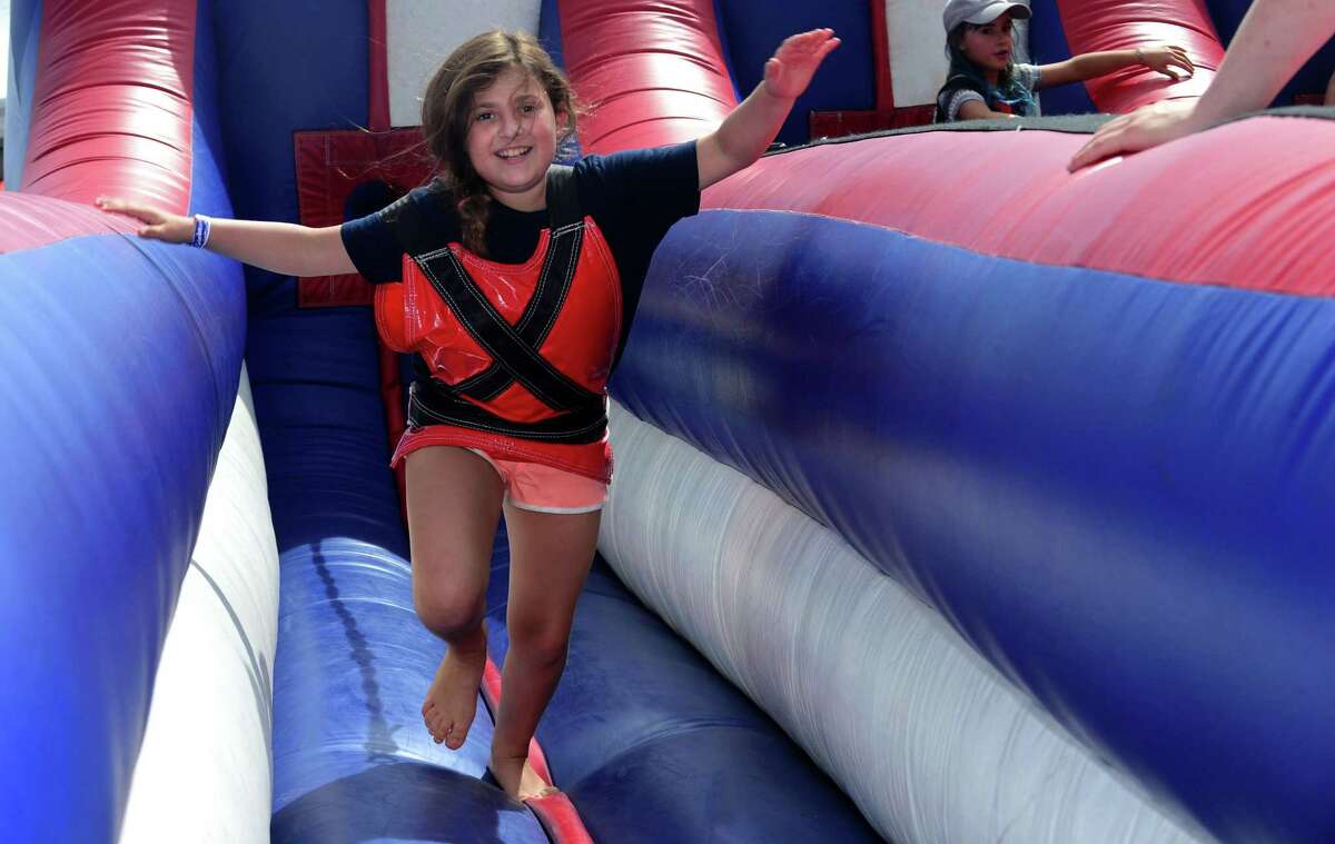 Alexa Fields of Greenwich plays on the inflatable attactions during the 12th annual Blues & Views Festival Saturday, August 31, 2019, at the Levitt Pavillion in Westport, Conn. A Fairfield County tradition since 2008, the festival continues Sunday and features a variety of established bands and soon-to-be-famous acts.