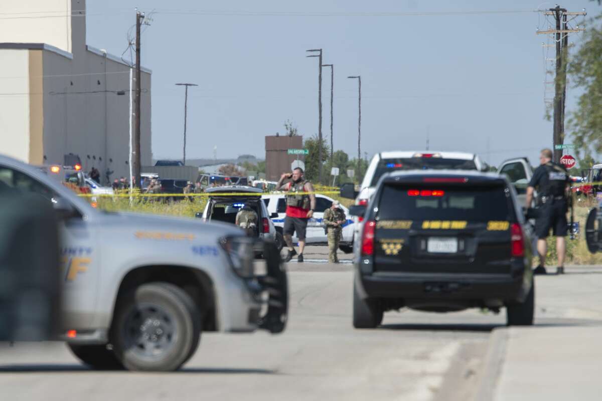 Odessa and Midland police and sheriff's deputies surround the area behind Cinergy in Odessa where one shooter who stole a mail truck 08/31/19 was detained and killed. Tim Fischer/Reporter-Telegram