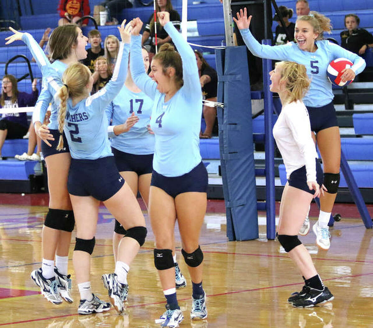 Jersey’s (from left) Abby Manns, Sally Hudson (2), Boston Talley (17), Bella Metzler (4), Sydney Gillis and Clare Breden (5) celebrate the final point of their three-set championship victory over CM on Saturday at the Roxana Tourney.