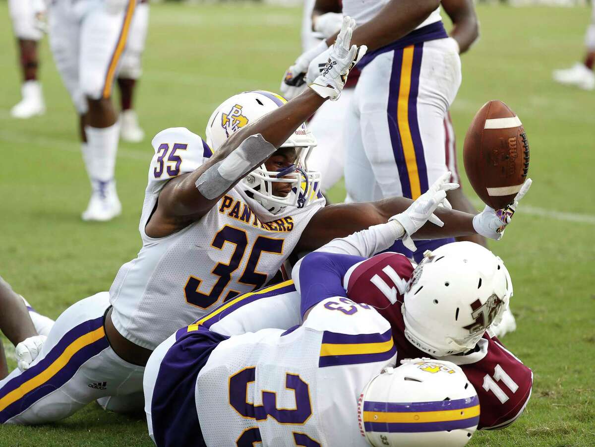 Texas Southern Tigers wide receiver Tren'Davian Dickson (11) ends up catching the pass in the end zone for a touchdown against Prairie View A&M Panthers defensive back Craig Rhodes Jr. (35) and safety Tariq Mulmore (33) in the first quarter of a college football game at BBVA Stadium, 8/31/19, in Houston.