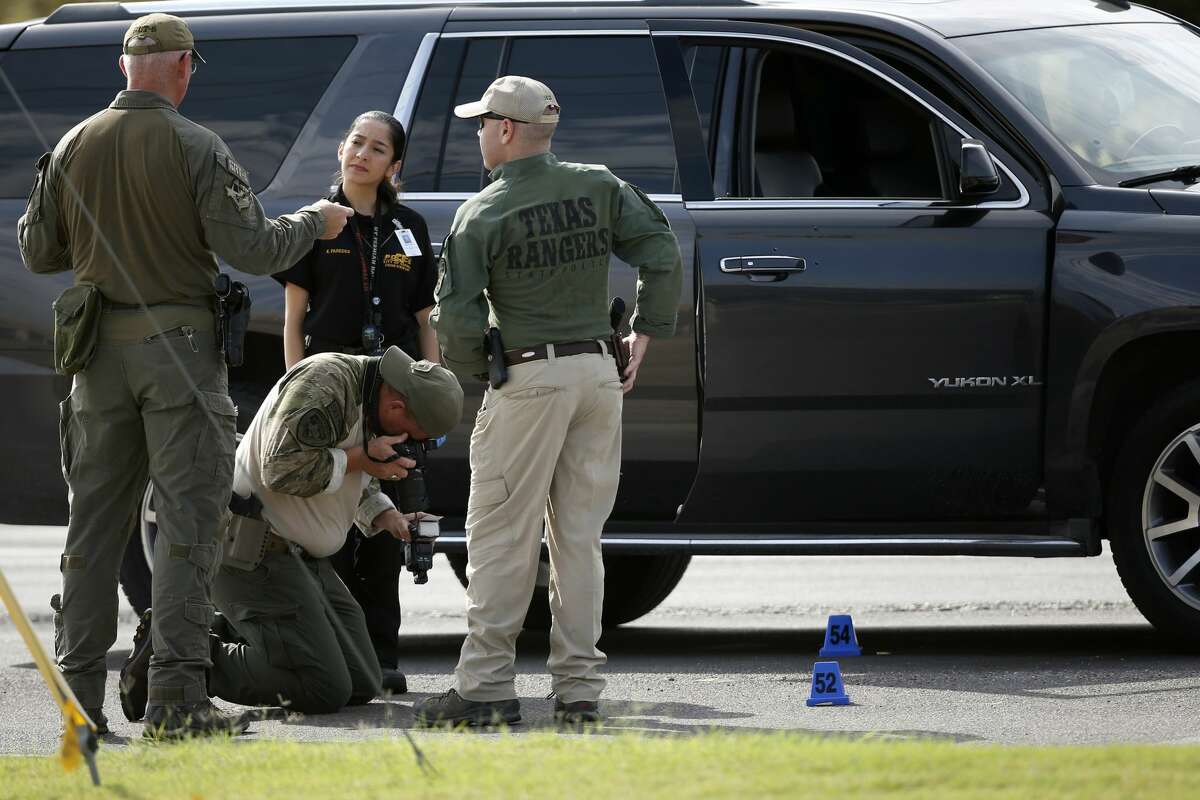 Law enforcement officials process a scene involved in Saturday's shooting, Sunday, Sept. 1, 2019, in Odessa, Texas. The death toll in the West Texas shooting rampage increased Sunday as authorities investigated why a man stopped by state troopers for failing to signal a left turn opened fire on them and fled, shooting more than a dozen people as he drove before being killed by officers outside a movie theater. (AP Photo/Sue Ogrocki)