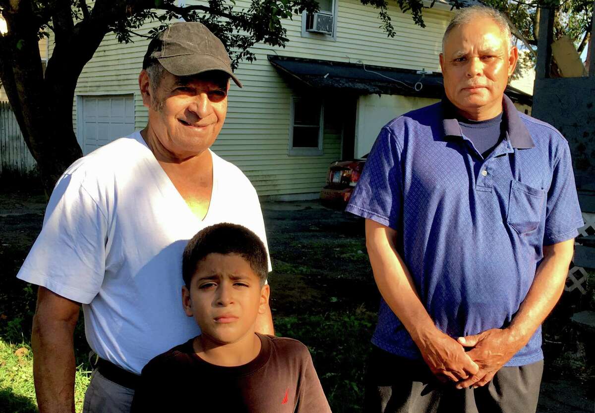 Fausto Canelas, left, from Honduras, with his grandson Emmanuel, 7, and Juan Mejia, from El Salvador. The two men live in Bridgeport under the Temporary Protected Status program and work as building cleaners in Norwalk with 32BJ SEIU.