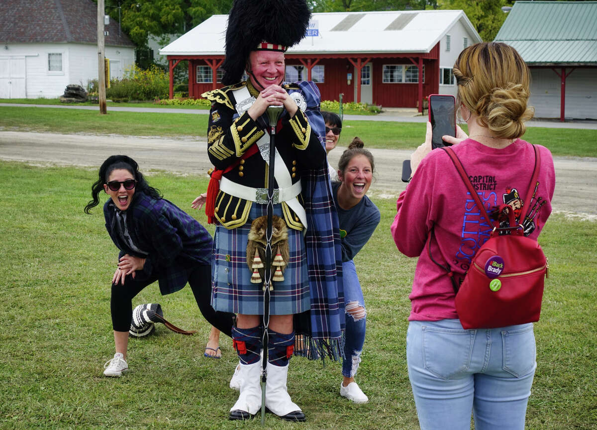 Lauren Brady, foreground, takes a photo of her sisters, Caitlin Brady, left, Nikki Brady, right, and their mom, Ann Brady, as the pose with their dad, and Ann's husband, Joe Brady at the Capital District Scottish Games at the Altamont Fairgrounds on Sunday, Sept. 1, 2019, in Altamont, N.Y. Joe Brady has been the drum major of the games for over 35 years. The Bradys are all from Peekskill. (Paul Buckowski/Times Union)