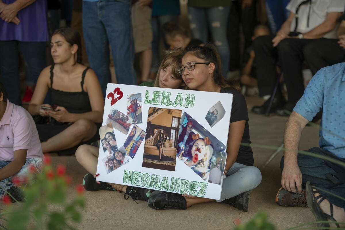 Celeste Lujan, left, and Yasmin Natera hold a sign for shooting victim Leilah Hernandez during a vigil Sunday, Sept. 1, 2019 at the University of Texas of the Permian Basin.
