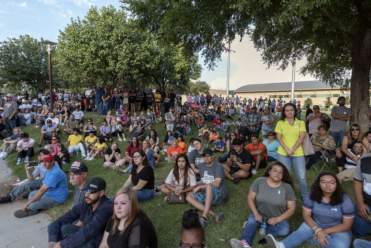 People attend a vigil for victims of a shooting spree the day before, Sunday, Sept. 1, 2019, at the University of Texas of the Permian Basin, in Odessa, Texas. (Jacy Lewis/Reporter-Telegram via AP)