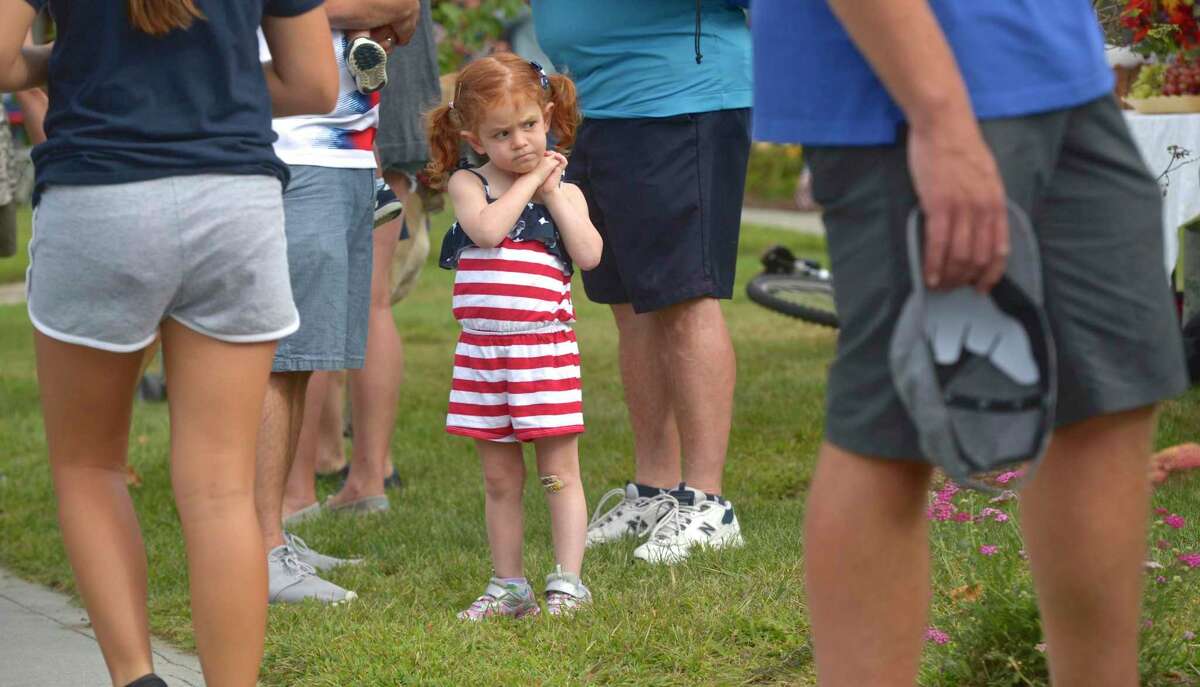 Aubrey Santora, 5, of Newtown waits for the start of the 2019 Newtown Labor Day Parade, Monday, September 2, 2019, in Newtown, Conn.