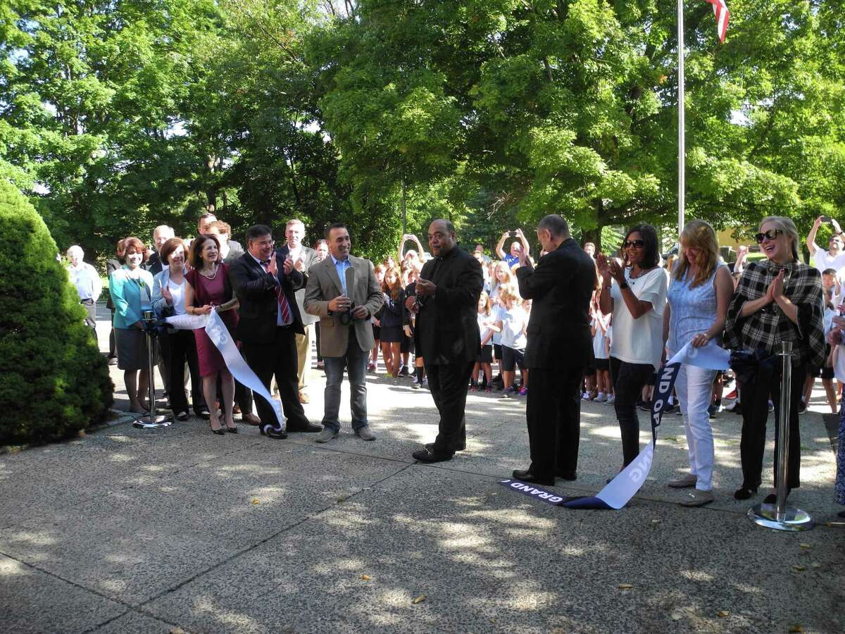 Cutting the ribbon to celebrate the opening of Our Lady of Fatima Catholic Academy are, from left, Wilton Library Executive Director Elaine Tai-Lauria, Selectwoman Lori Bufano, state Rep. Gail Lavielle, Dr. Steven Cheeseman, superintendent of schools for the Diocese of Bridgeport, Kevin Vallerie, president of Our Lady of Fatima's school board, Father Reggie Norman, pastor of Our Lady of Fatima Church, Bishop Frank Caggiano of the Diocese of Bridgeport, and parents Clara Tavera-Davis, Liz Halpin, and Mara Fleming. The ribbon-cutting took place Aug. 30, 2019, in Wilton, Conn.