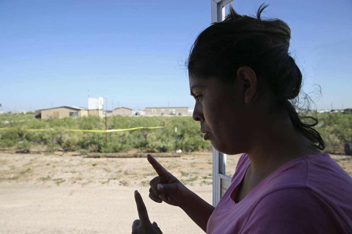 Veronica Alonzo, 29, talks about interactions with her neighbor, Seth Ator, 36, at their West Odessa, Texas neighborhood, Monday, Sept. 2, 2019. Ator lived in a aluminum shack, background, without electricity or running water in West Odessa. He is suspected in killing seven and injuring 22 people in a shooting rampage that started on IH-20 between Odessa and Midland, Texas, Saturday. Alonzo said that one time, Ator went to her trailer home with a rifle and complained about a trash issue.