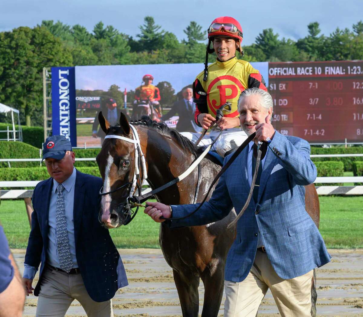Jose Ortiz who has been crowned leading jockey for the 2019 meeting is all smiles after winning the 115th running of The Runhappy Hopeful on Basin is lead to the winner?•s circle by owner Terry Green, right and assistant trainer Scott Blasi at the Saratoga Race Course Monday Sept. 2, 2019 in Saratoga Springs, N.Y. Photo Special to the Times Union by Skip Dickstein