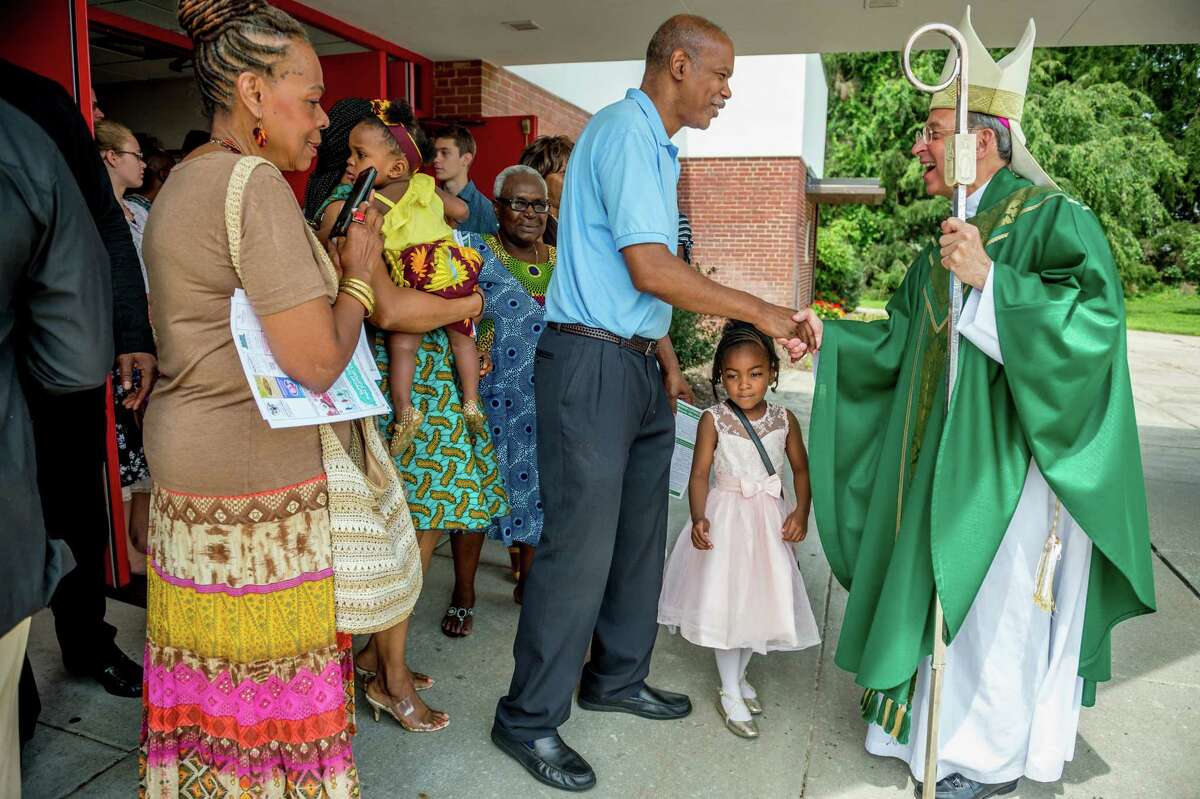 Archbishop William Lori, head of the Archdiocese of Baltimore, greets parishioners after delivering Sunday Mass at Holy Family Catholic Church on July 14, 2019, in Randallstown, Md.