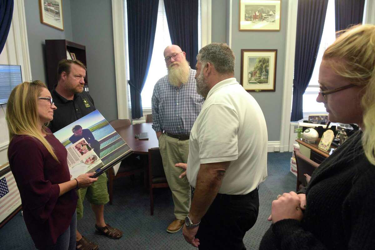 The family of Brian Cody Waldron, who died from a drug overdose in August of 2019, leave a meeting with Mayor Pete Bass and State Representative Bill Buckbee in the mayors office on Tuesday. Mother Tracey Morrissey, left, step-father Tony Morrissey and fiancé Makayla Showalter, , right. August 27, 2019, in New Milford, Conn.