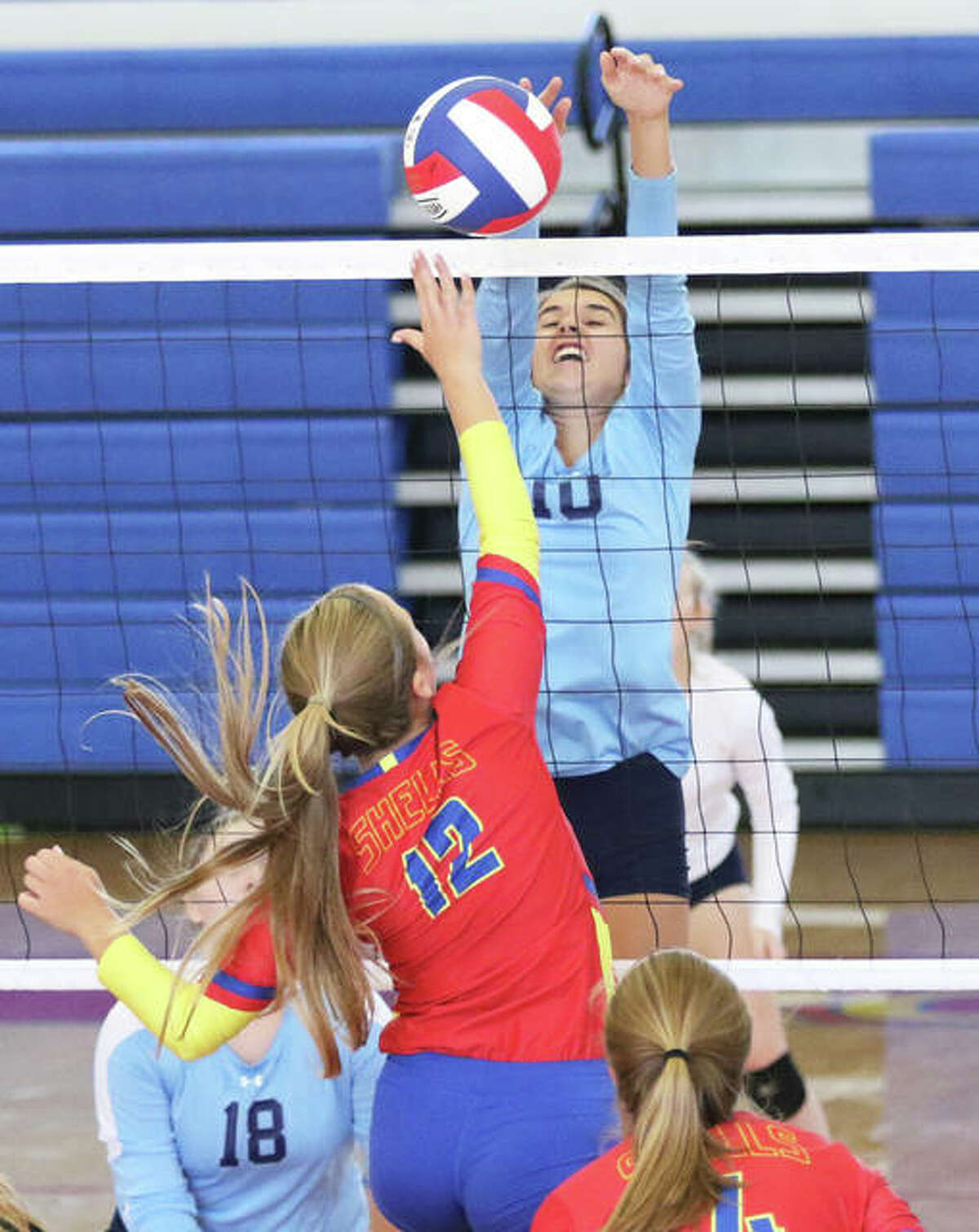 Jersey’s Abby Manns (10) scores on a block of an attack by Roxana’s Olivia Mouser.