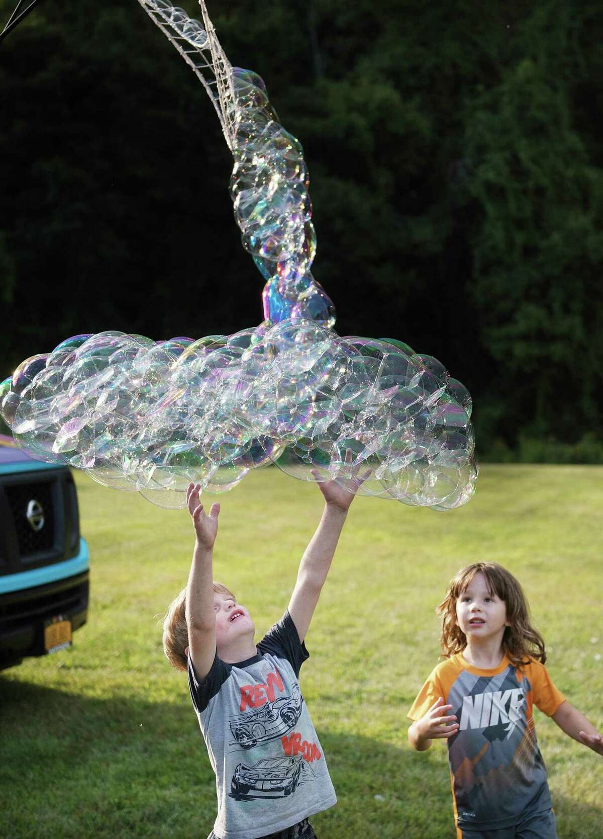 Colin McLaughlin catches bubbles during the Barlow Mountain back-to-school social Friday, Aug. 30.