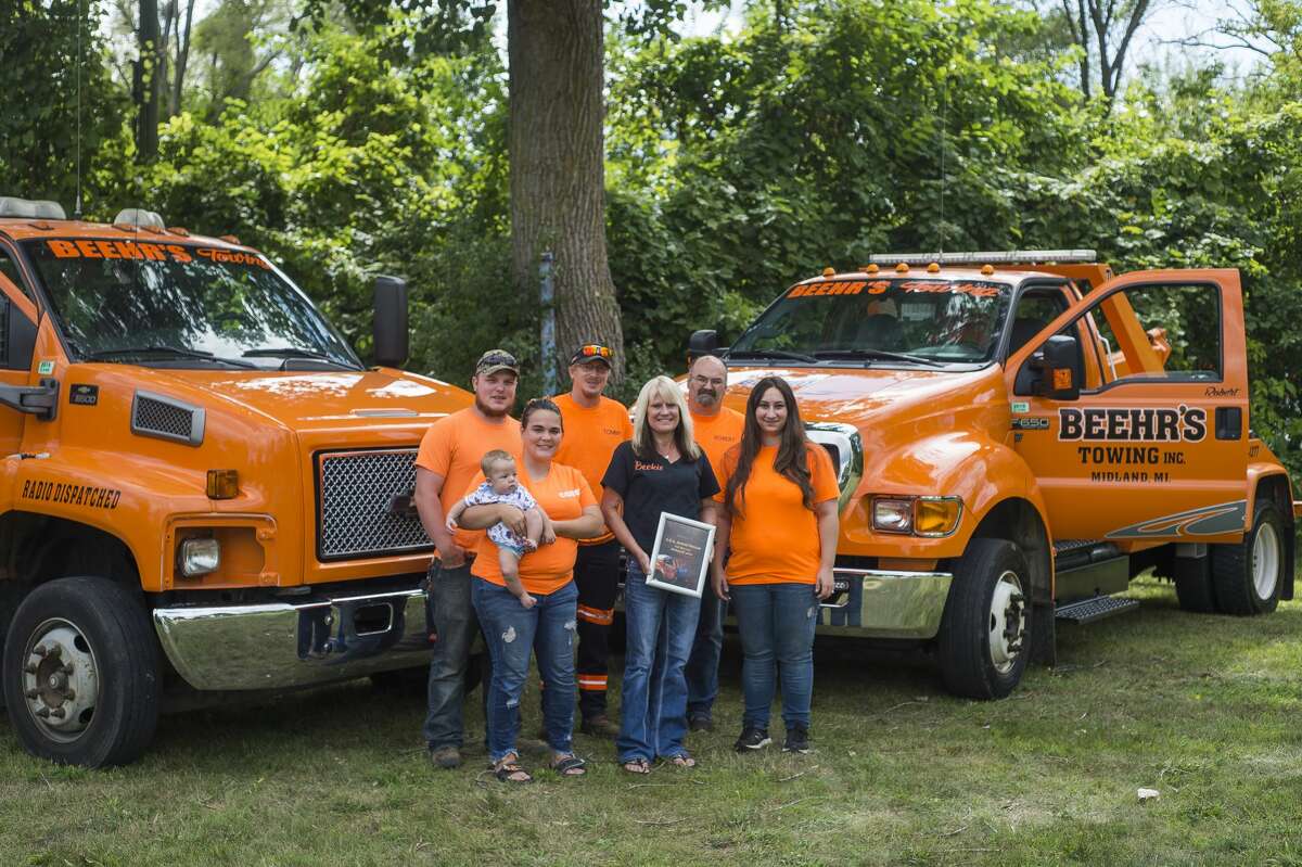 The staff of Beehr's Towing, including owner Beckie Baybeck, center, pose for a portrait Friday, Aug. 23, 2019 in Midland. (Katy Kildee/kkildee@mdn.net)