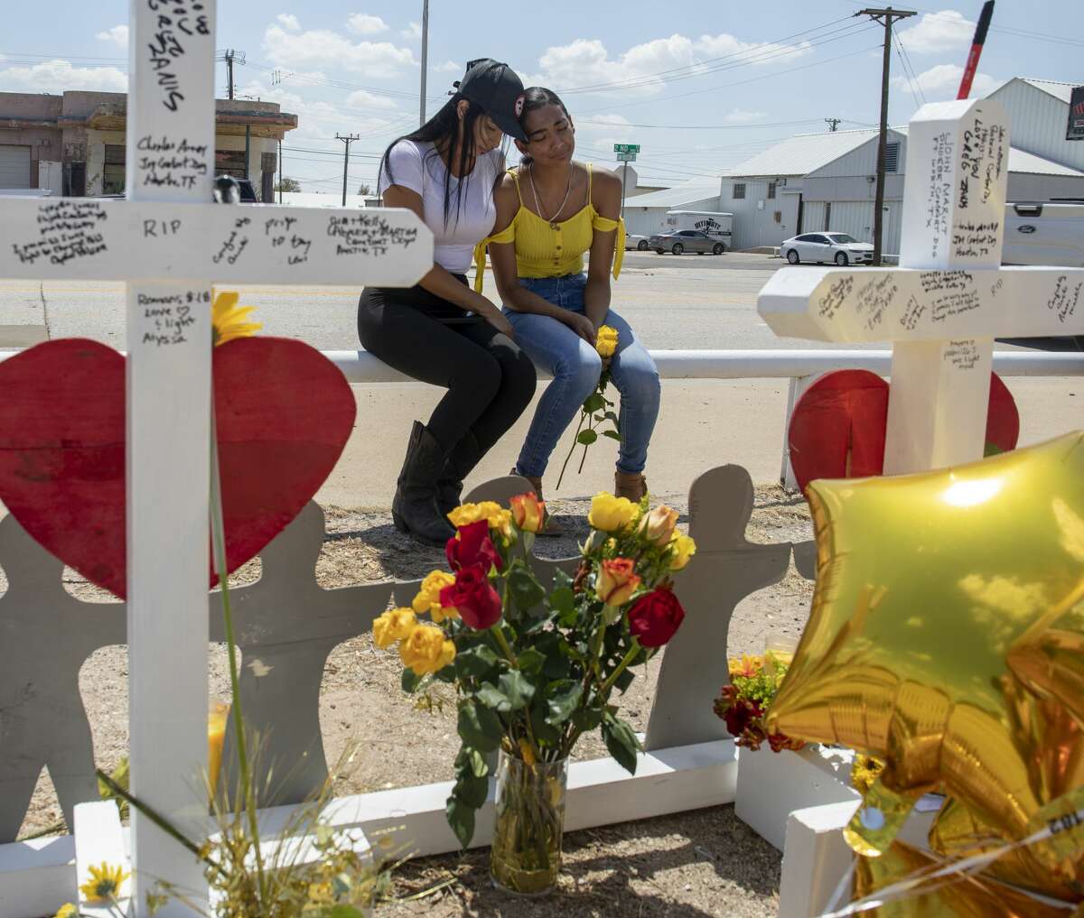 Kimberly Juarez and her mother, Lizeth Aguilar, mourn at white crosses, made by Greg Zanis from Illinois, that were placed on Tuesday, Sept. 3, 2019, at 2nd Street and Sam Houston Avenue in Odessa, Texas. Juarez's best friend, Leilah Hernandez, died in the mass shootings on Saturday, Aug. 31.