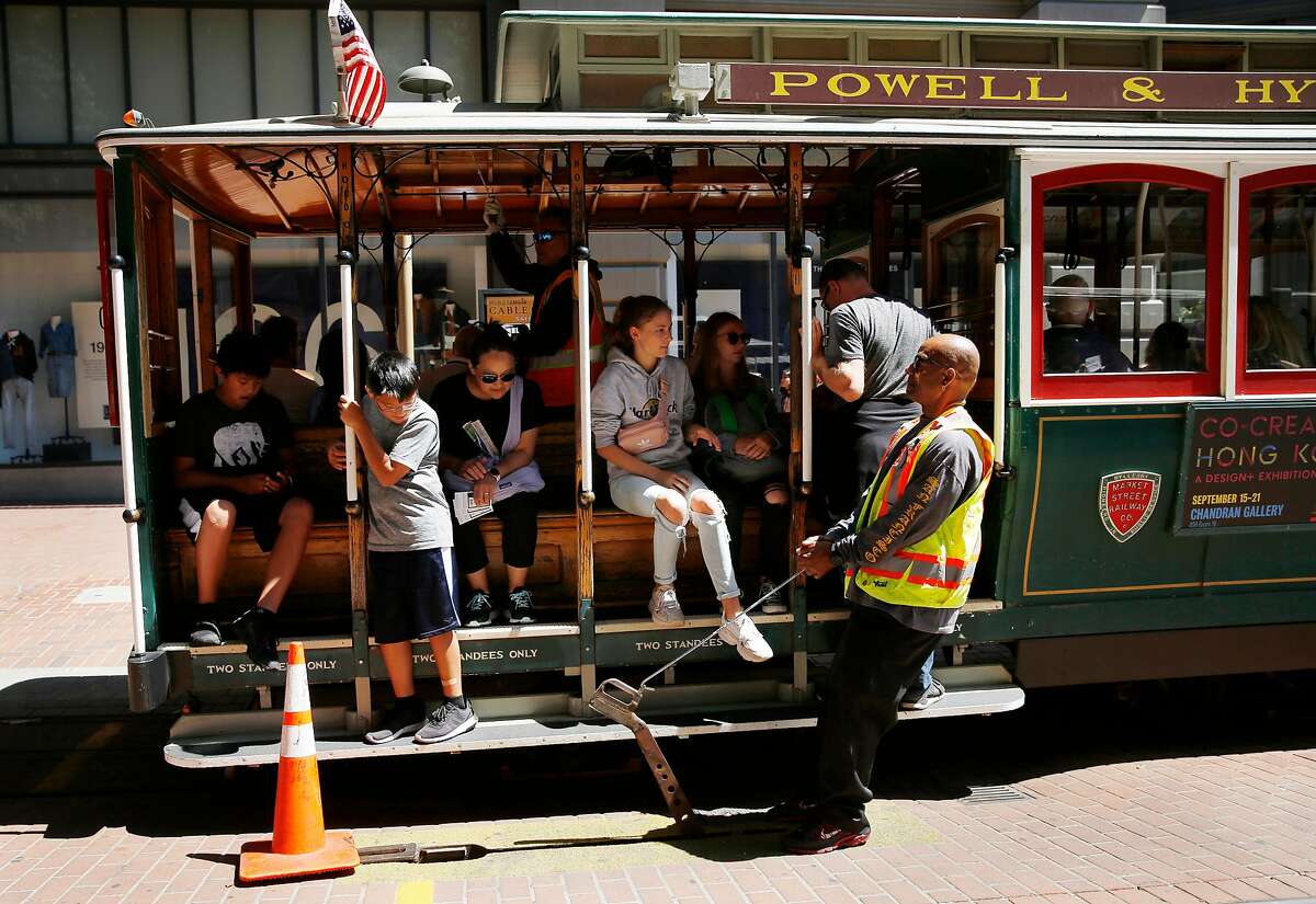 A cable car expediter lifts a gypsy while working at the Powell Street turnaround on Friday, August 30, 2019 in San Francisco, CA.