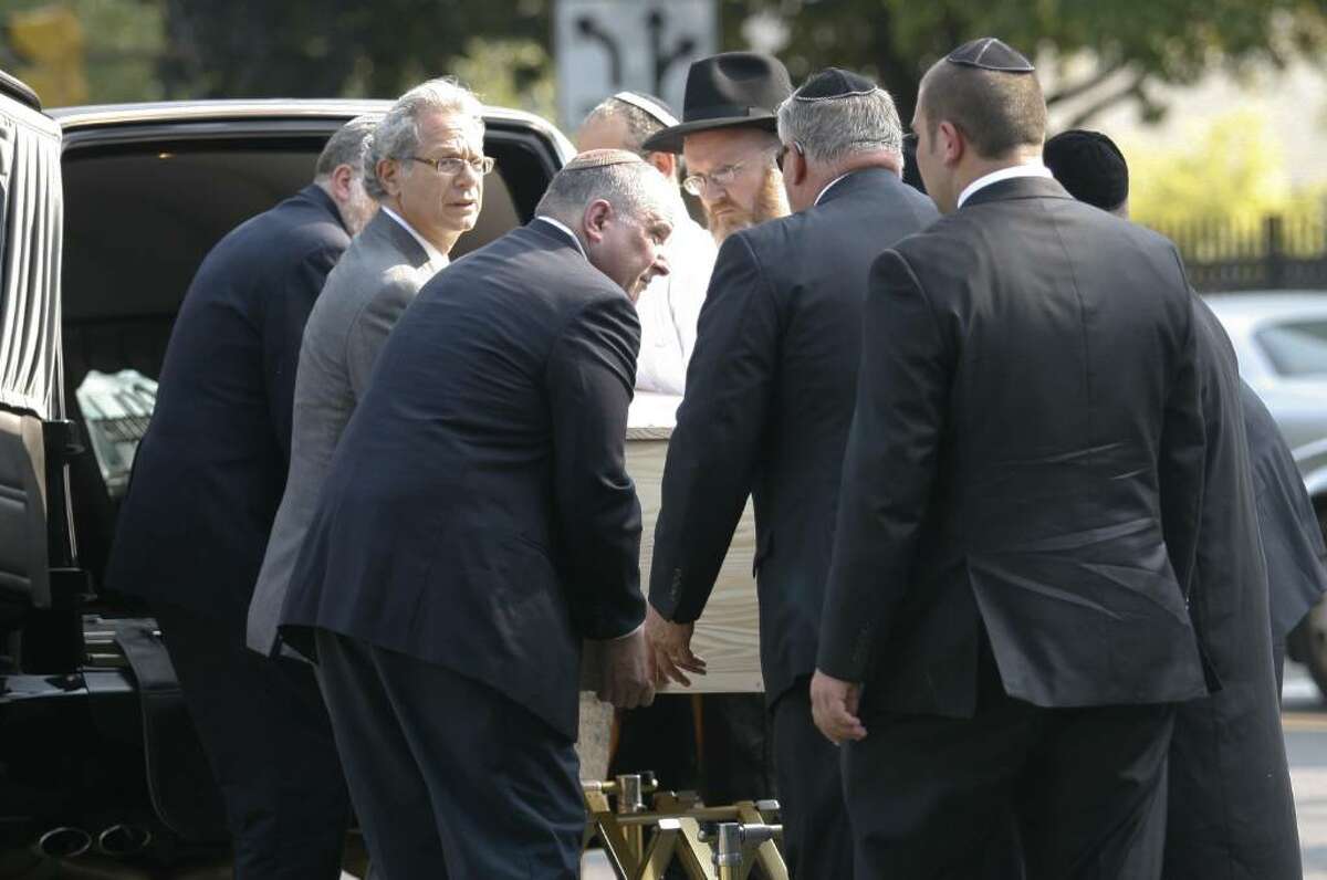 Pallbearers transport the casket of Manchester shooting victim Louis Felder, 50, of Stamford, at Congregation Agudath Sholom in Stamford, Conn. on Wednesday, August 4, 2010.