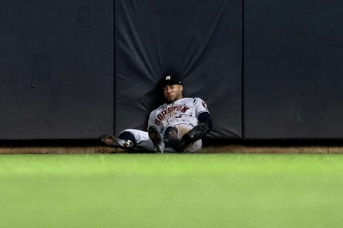 Astros center fielder George Springer hits the ground after making a catch during the fifth inning Tuesday against the Brewers in Milwaukee.