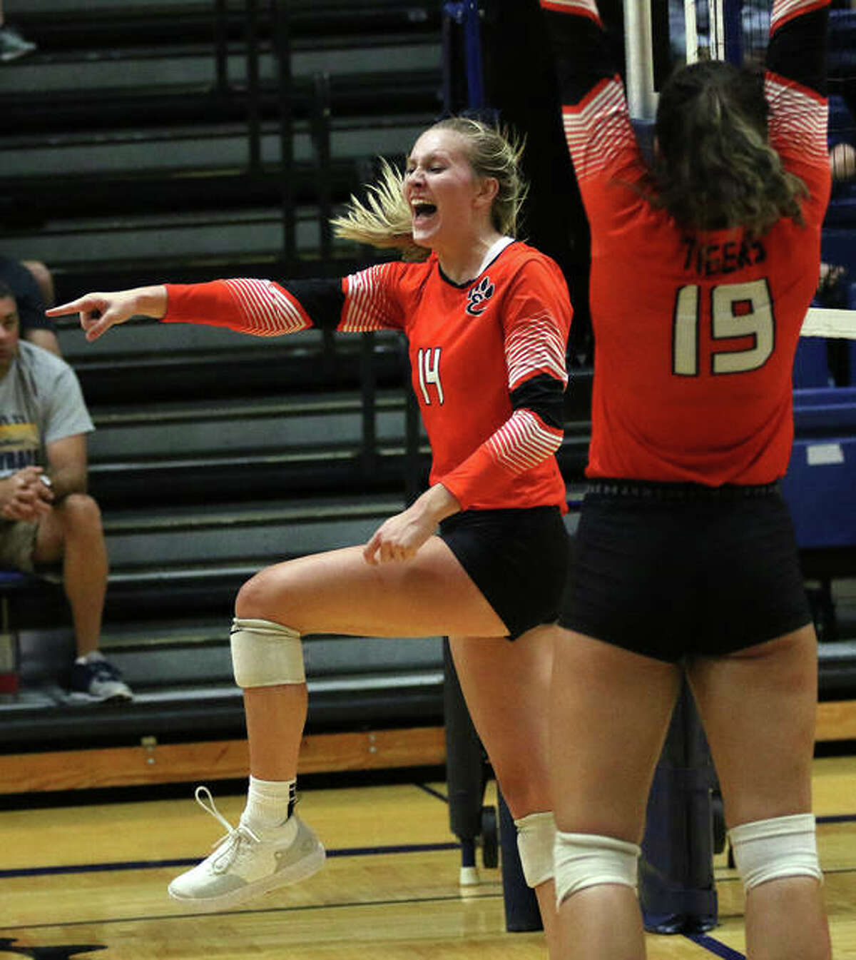 Edwardsville’s Maddie Isringhausen (left) celebrates one of her career-high 14 kills along with teammate Rhianna Huebner during the third set Tuesday at Panther Dome in O’Fallon.