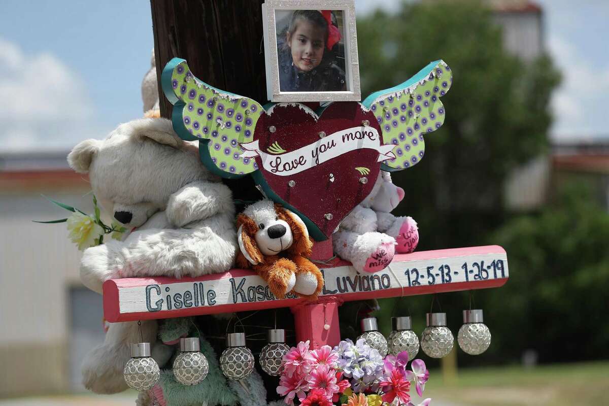 A memorial for Giselle Luviano surrounds a pole near 75th Street and Harrisburg Monday, Aug. 12, 2019, in Houston.
