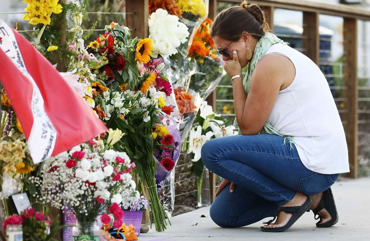 SANTA BARBARA, CALIFORNIA - SEPTEMBER 03: A woman looks emotional as she kneels at a makeshift memorial in Santa Barbara Harbor for victims of the Conception boat fire on September 3, 2019 in Santa Barbara, California. Authorities believe none of the 34 people below deck survived after the commercial scuba diving ship caught fire and sank, while anchored near Santa Cruz Island, in the early morning hours of September 2. Five crew members survived. (Photo by Mario Tama/Getty Images)