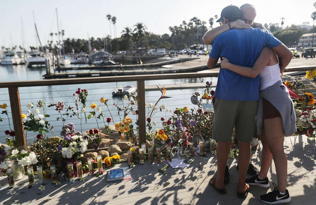 SANTA BARBARA, CALIFORNIA - SEPTEMBER 03: People embrace at Santa Barbara Harbor at a makeshift memorial for victims of the Conception boat fire on September 3, 2019 in Santa Barbara, California. Authorities have found 25 bodies thus far after the diving ship Conception caught fire and sank while anchored near Santa Cruz Island in the early morning hours of September 2. Five crew members survived. (Photo by Mario Tama/Getty Images) *** BESTPIX ***