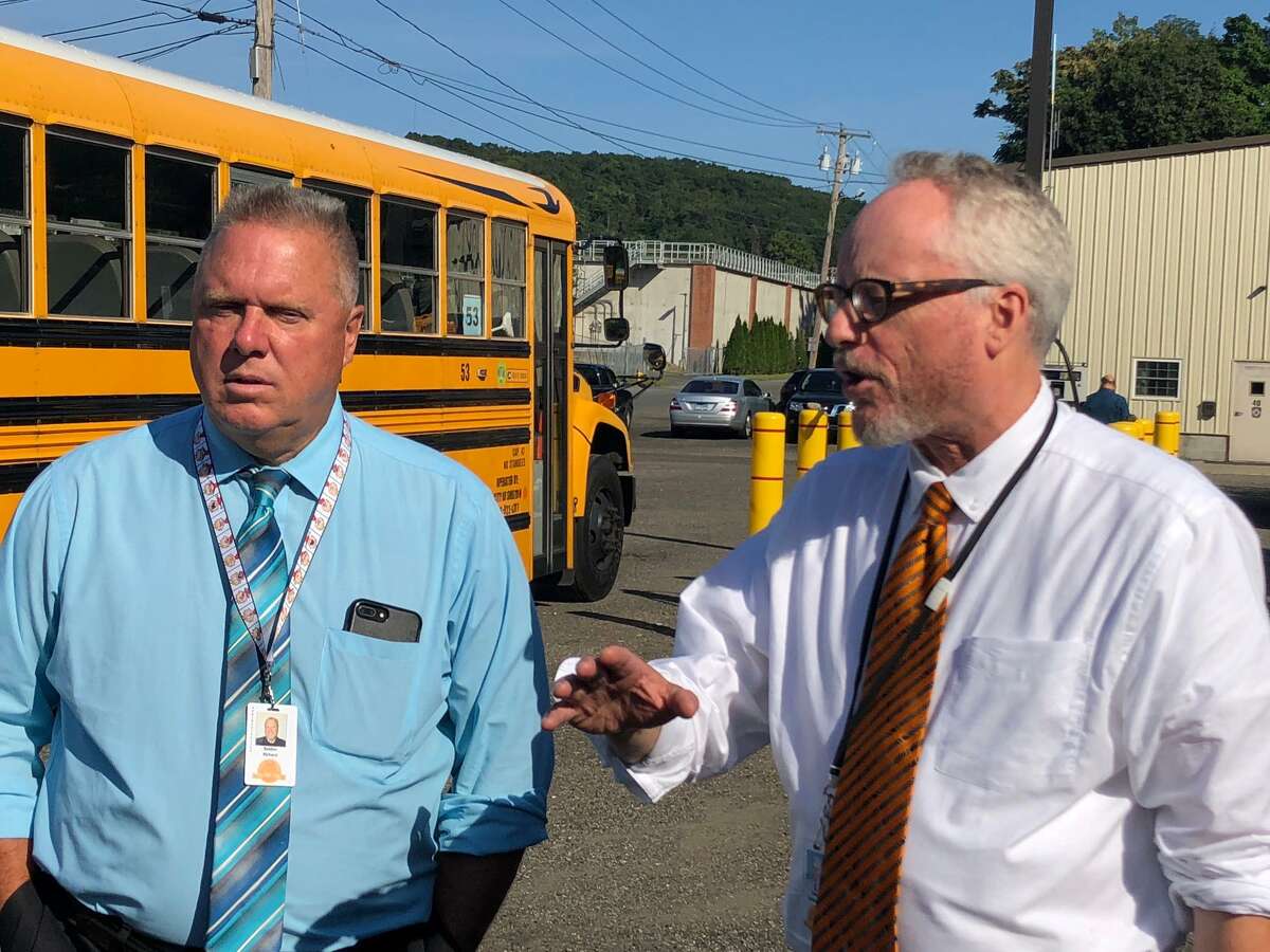 School Superintendent Dr. Chris Clouet, right, with school Finance Director Rick Belden outside the bus garage on Tuesday, Sept. 3, announced schools will open Wednesday, Sept. 4.
