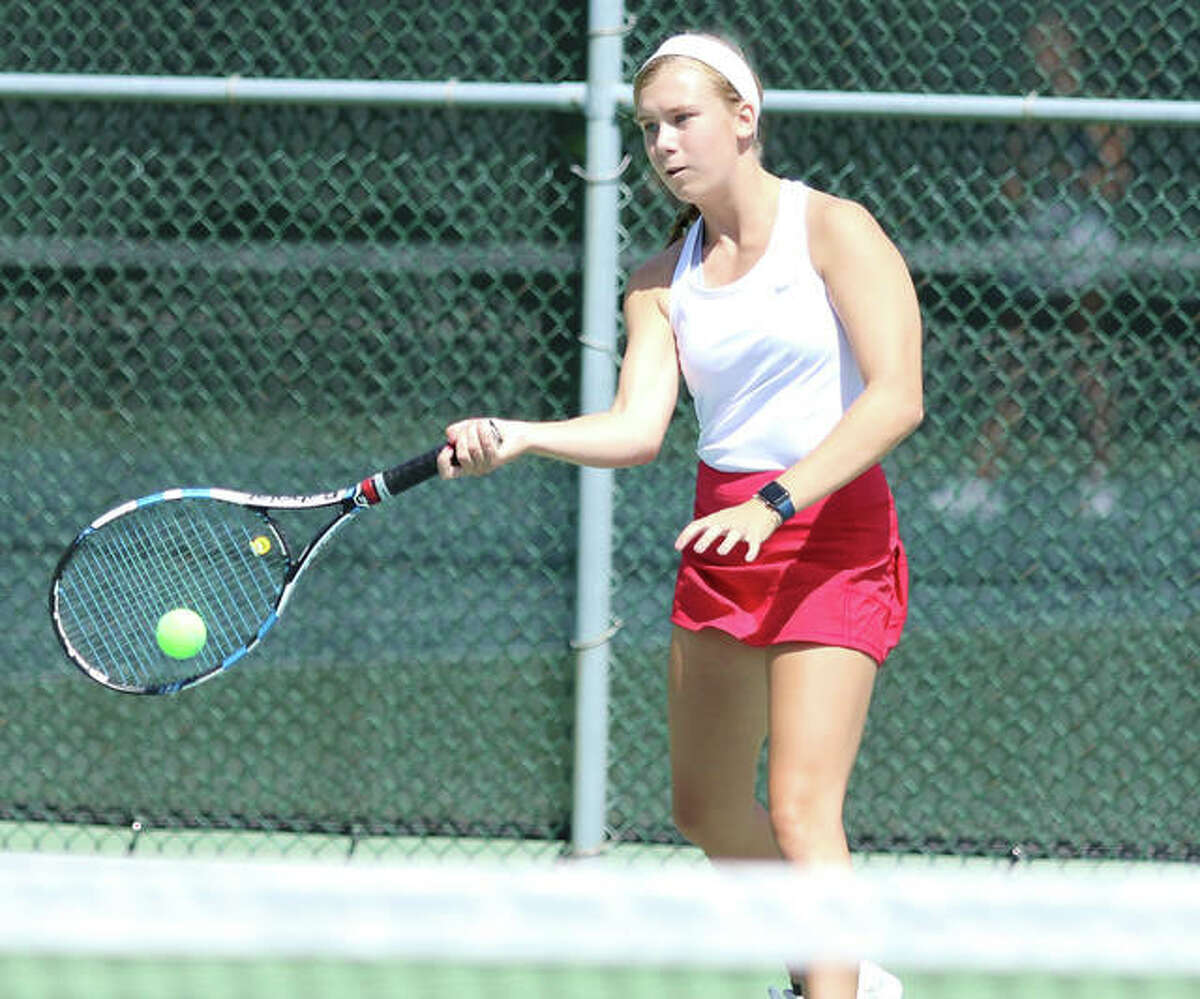 Alton’s Nikki Lowe was one of three Redbirds to post victories in singles and doubles in a dual win over Jersey on Tuesday at Alton High in Godfrey.