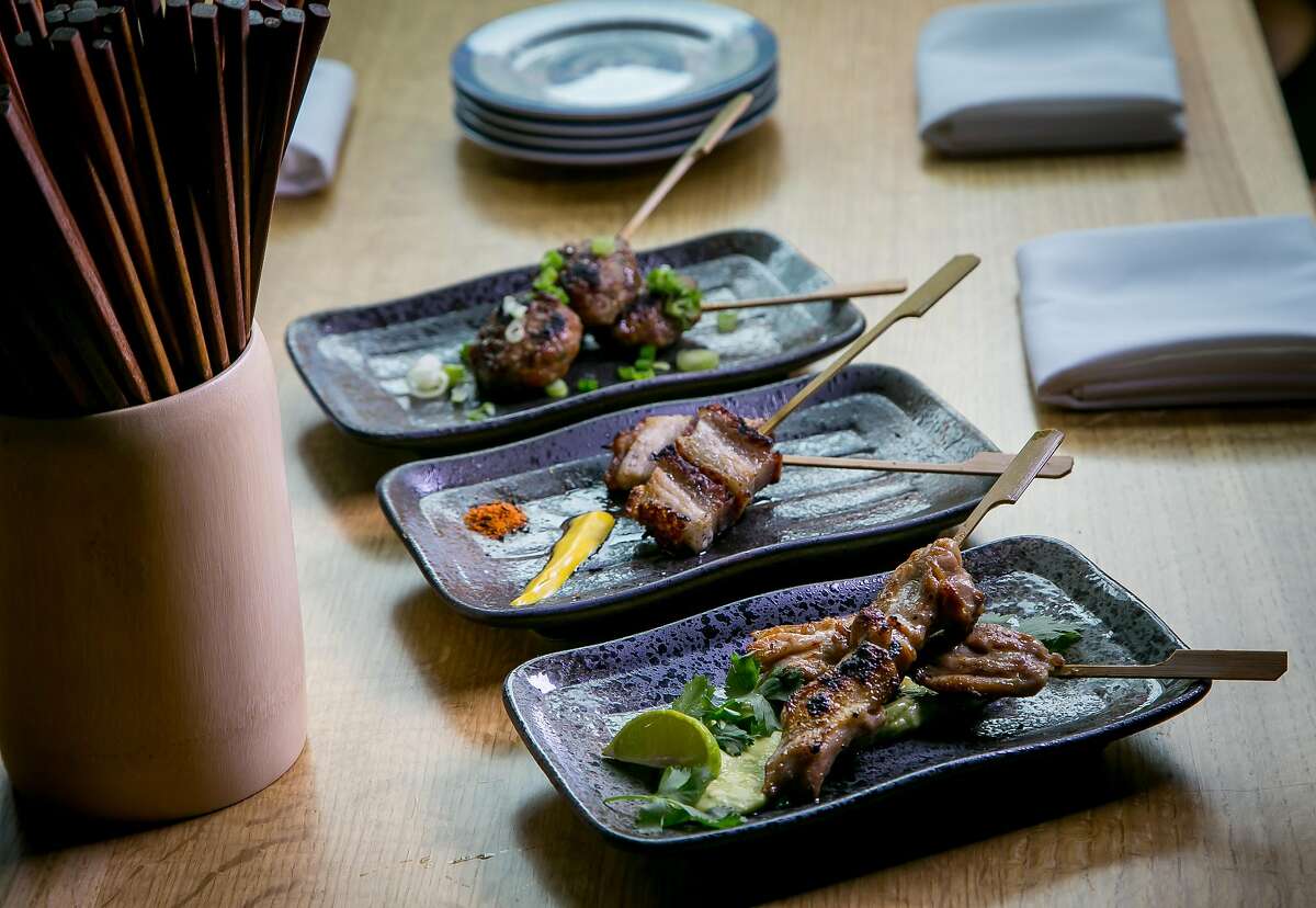 Skewers; front to back; Chicken Avocado, Pork Belly, and Japanese Meatball at Chubby Noodle in San Francisco, Calif., are seen on July 21st, 2015.