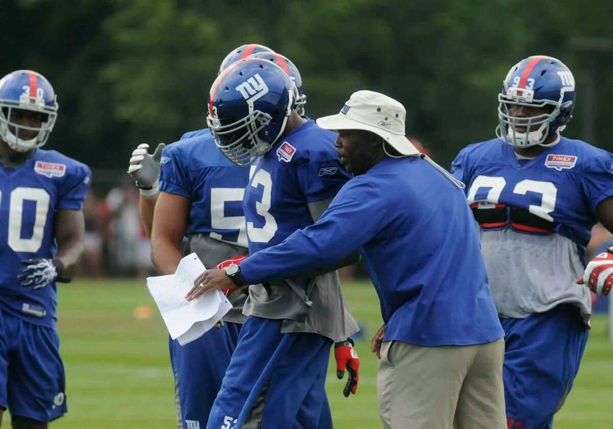 New York Giants Defensive Coordinator Perry Fewll works with his unit during Giants Camp at the University at Albany in Albany,New York 8/03/2010. ( Michael P. Farrell / Times Union )
