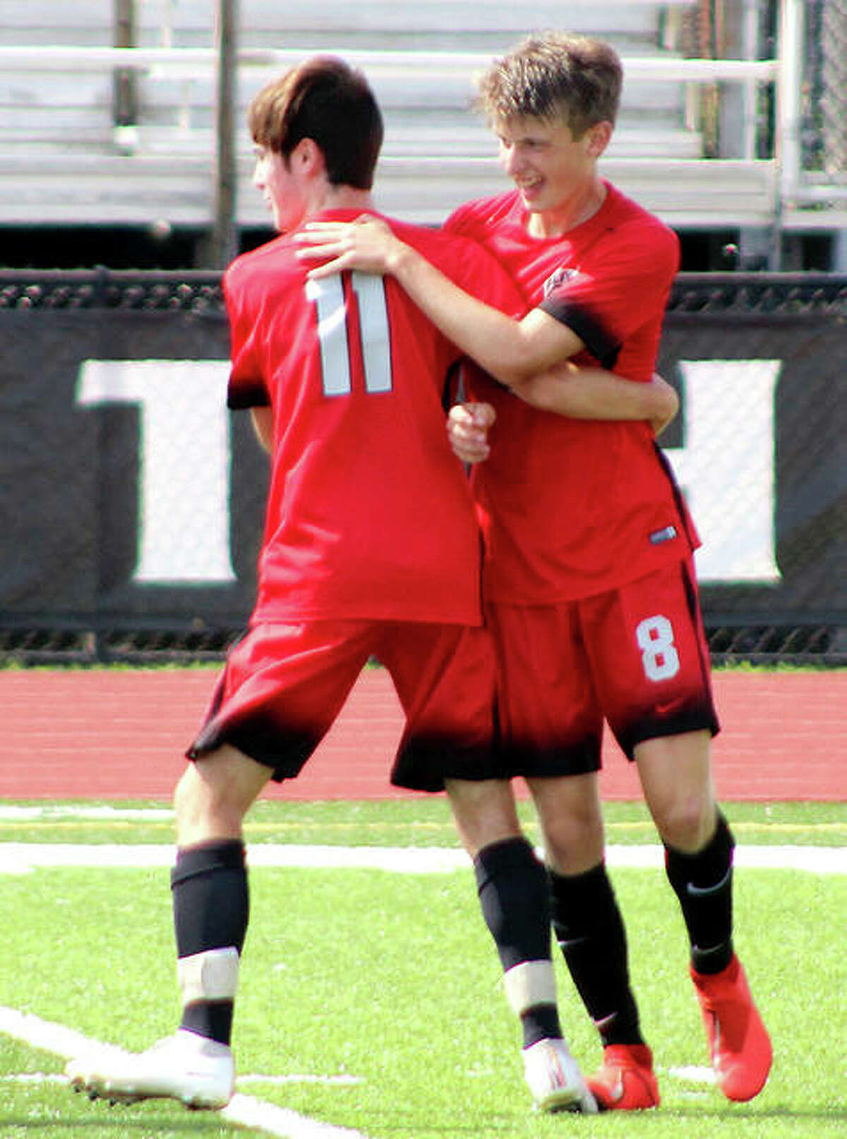 Alton’s Brayden Decker (8) had a goal and two assists Tuesday in his team’s 4-2 win over Belleville East. he is shown being congratulated by teammate Hayden Batchelor after a goal Saturday against Rochester in the Kahok/Redbird Tournament.