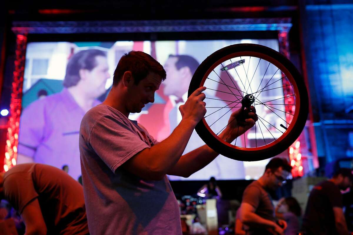 Andrew Kavanah helps build bikes for students at McCoppin Elementary School at Emporium Arcade Bar in San Francisco, Calif., on Tuesday, September 3, 2019.