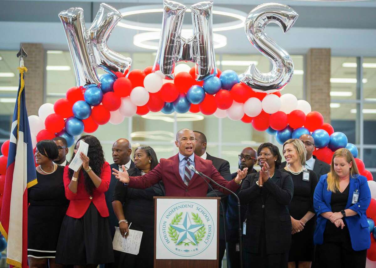 Kashmere High School principal Reginald Bush stands with his staff during a celebration marking the school’s meeting of state expectations for the first time in 11 years at the school in Houston, Thursday, Aug. 15, 2019.