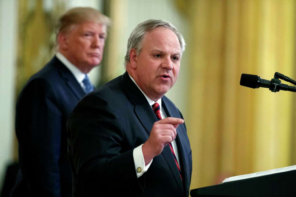 In this July 8, 2019 file photo President Donald Trump listens as Secretary of the Interior David Bernhardt speaks during an event on the environment in the East Room of the White House in Washington. The Trump administration has finalized changes to enforcement of the landmark Endangered Species Act, a move it says will improve transparency and effectiveness but critics say will drive more creatures to extinction. Bernhardt unveiled the changes Monday. (AP Photo/Evan Vucci, File)