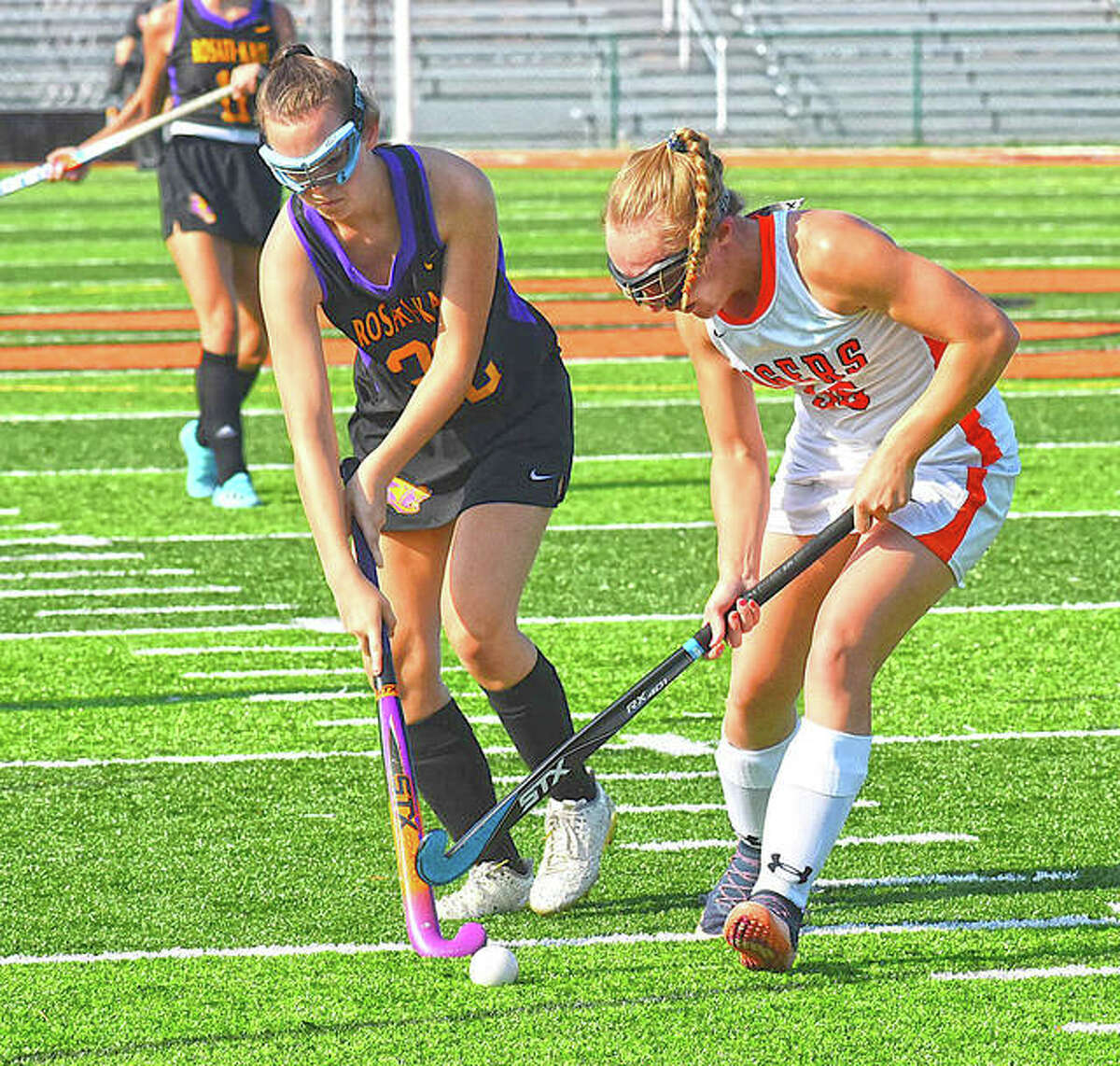 Edwardsville forward Mattie Norton battles through a defender to keep possession of the ball in the first half Wednesday.