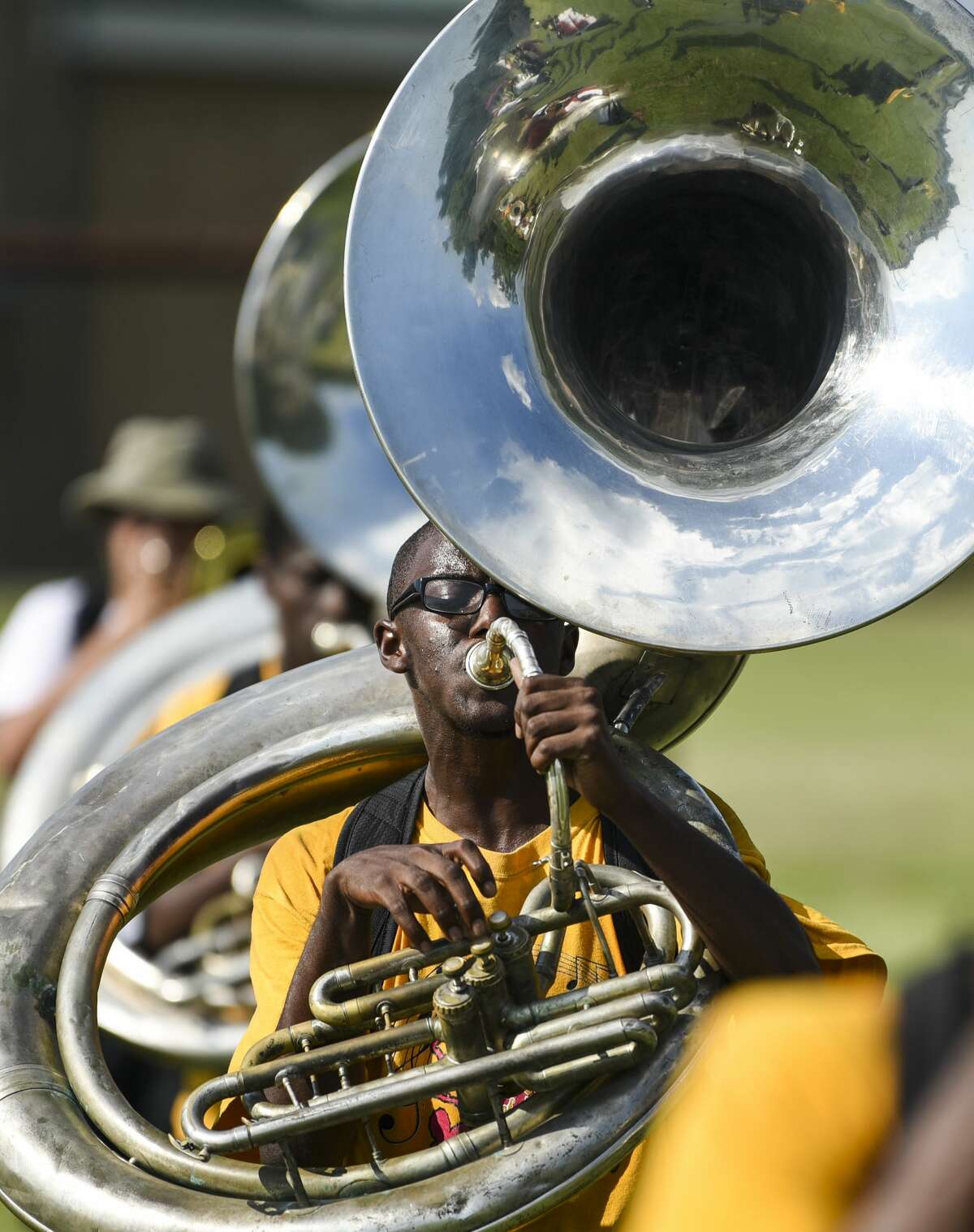 JerCore Jones plays the sousaphone with other members of Beaumont United's band during practice Tuesday afternoon. Beaumont will see temperatures in the high 90's through the weekend. Photo taken on Tuesday, 09/04/19. Ryan Welch/The Enterprise
