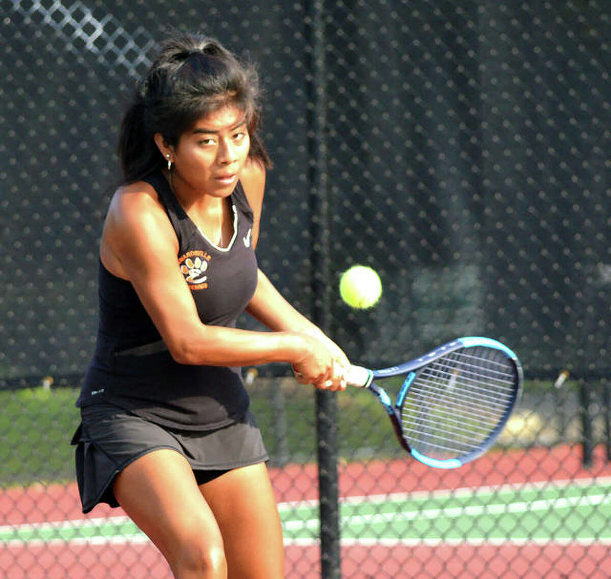 Edwardsville junior Chloe Trimpe hits a two-handed backhand during her No. 3 singles match Wednesday at St. Joseph’s Academy.