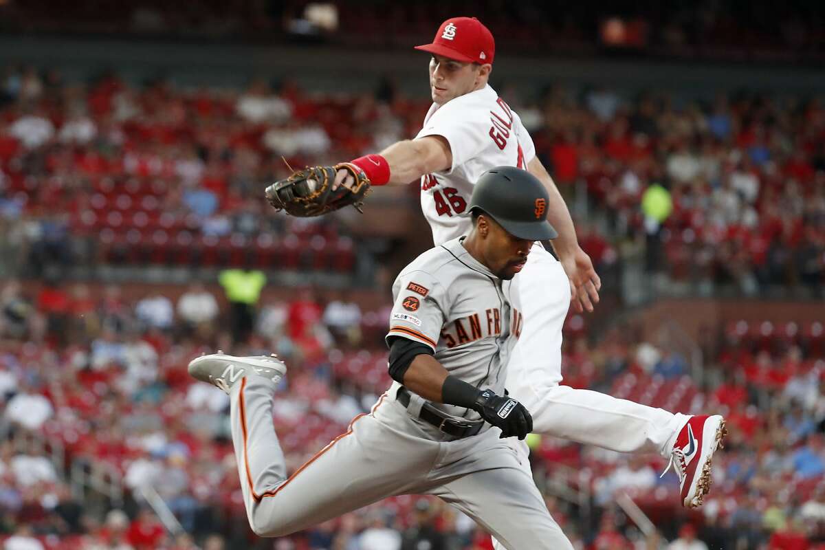San Francisco Giants' Jaylin Davis, front, is safe at first for a single as he avoids the tag from St. Louis Cardinals first baseman Paul Goldschmidt during the second inning of a baseball game Wednesday, Sept. 4, 2019, in St. Louis. (AP Photo/Jeff Roberson)