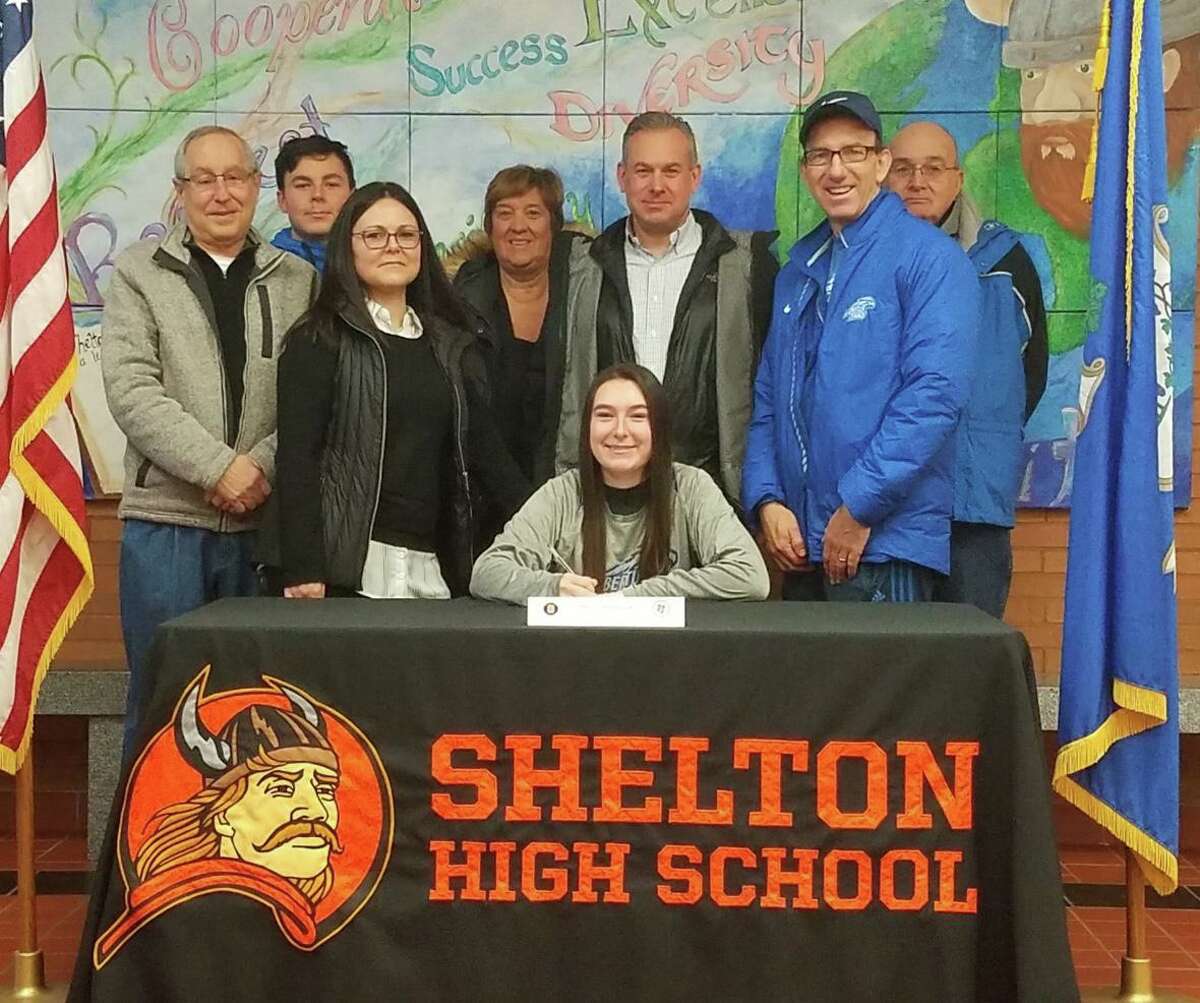 Maria Mandulak is surrounded by family and coaches when she signed a letter of intent to play women's tennis at Albertus Magnus College.