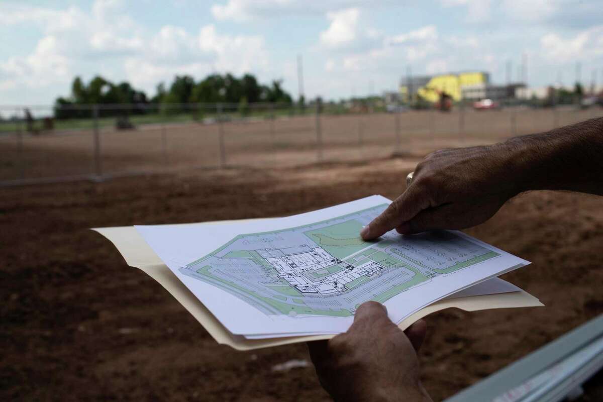 Fort Bend ISD’s chief operations officer, Oscar Perez Jr., displays a plan showing the burial site where the remains of 95 black prison laborers.