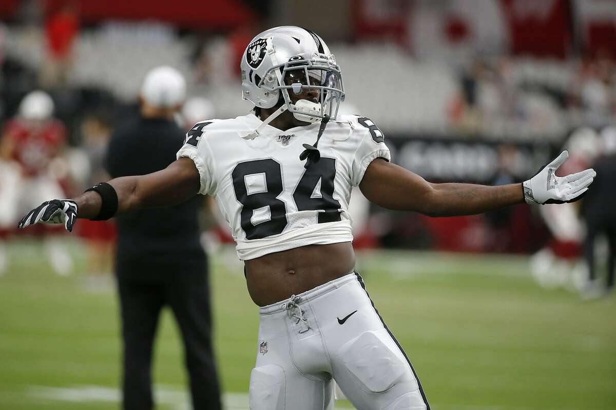 FILE - In this Aug. 15, 2019, file photo, Oakland Raiders wide receiver Antonio Brown (84) warms up for the team's NFL preseason football game against the Arizona Cardinals, in Glendale, Ariz. Brown is part of a new receiving corps that will join a revamped offensive line led by Trent Brown and a first-round running in Josh Jacobs that could provide quarterback Derek Carr with his best supporting cast in six seasons in the NFL. (AP Photo/Rick Scuteri, File)