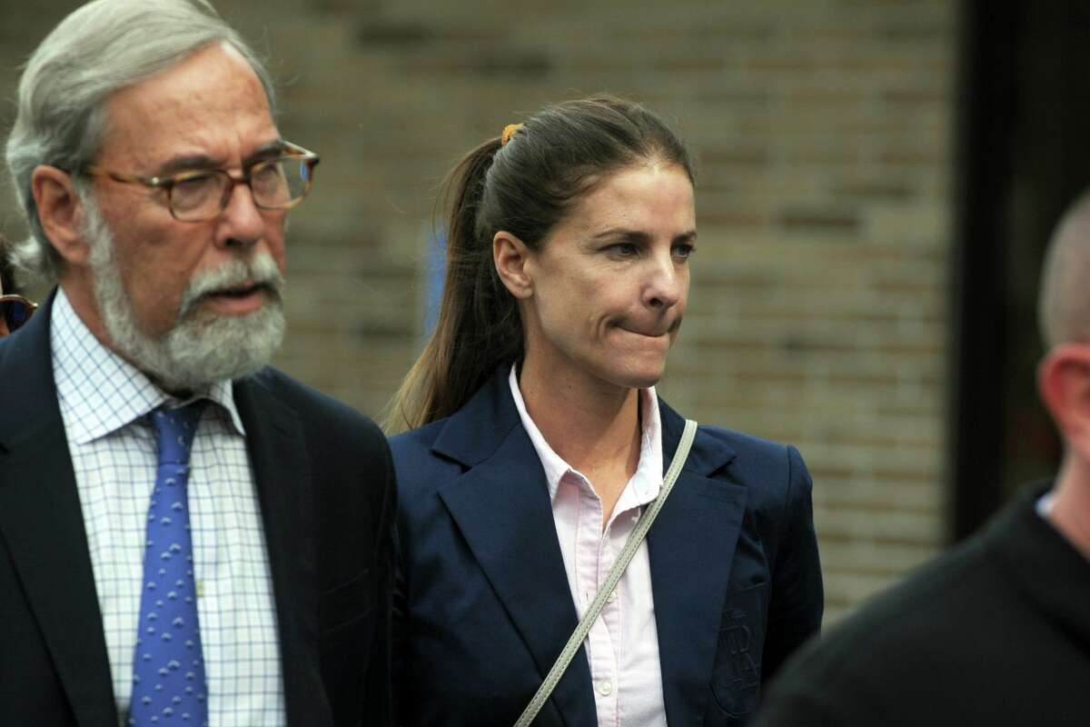 Michelle Troconis, with her attorney Andrew Bowman, leaves Connecticut State Police Troop G in Bridgeport, Conn. after turning herself in to face additional charges in the Jennifer Dulos case Sept. 5, 2019.