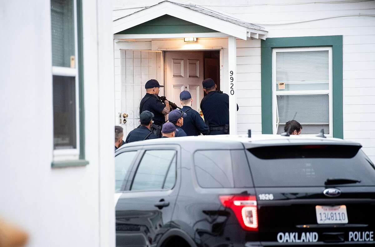 ** EMBARGOED TILL OAKLAND POLICE DEPARTMENT NOTIFIES SFC THAT THE OPERATION IS COMPLETE ** Police officers execute a search warrant at an Oakland, Calif., home on Thursday, Aug. 29, 2019. The raid was part of a multi-city, multi-agency operation targeting robbers that police say stole shipments of smart phones from delivery drivers.