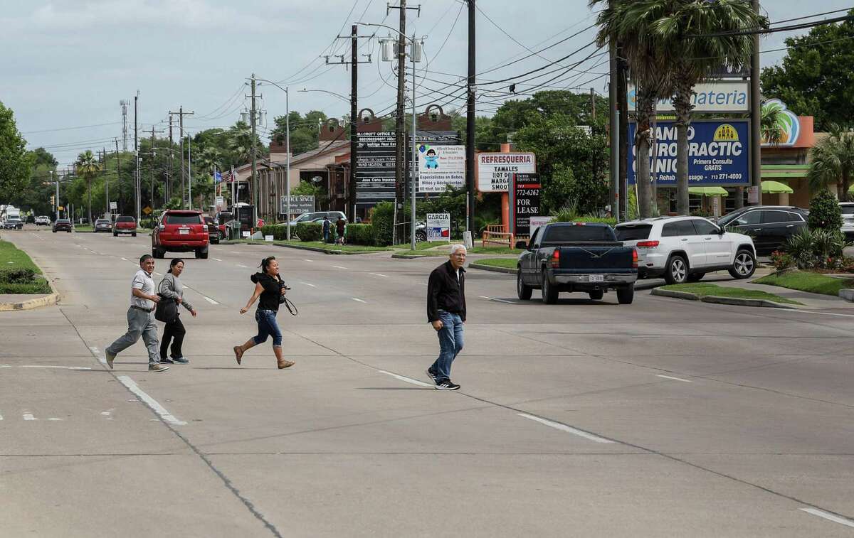 A group of people cross Hillcroft Avenue near Bellaire Boulevard on Tuesday, April 16, 2019, in Houston.