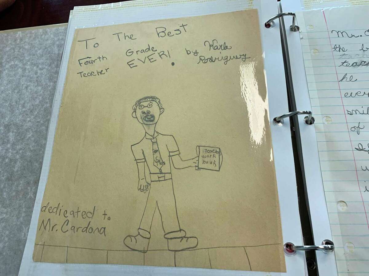 One of the pages in Education Commissioner Miguel Cardona’s scrapbook is a drawing and note from fourth grade student Karla Rodriguez, a student in his first class.