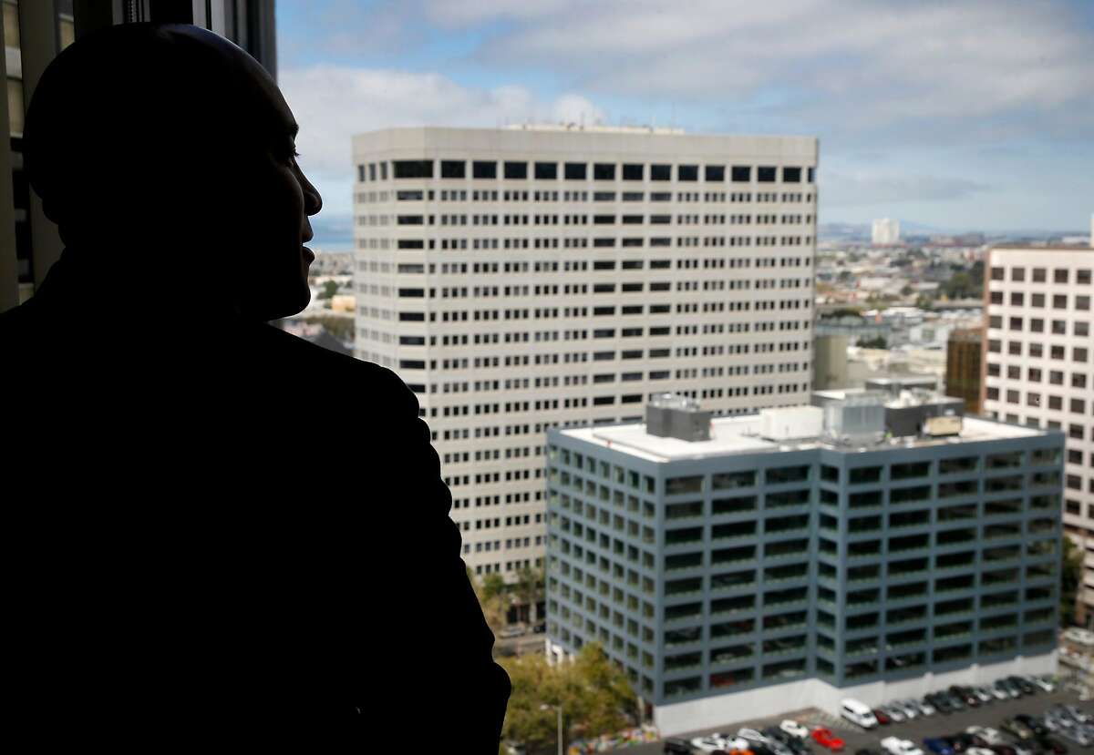 Rodd Lee, Interim Assistant General Manager of External Affairs for BART, views a new office building (lower right) from the 18th floor of the Kaiser Building in Oakland, Calif. on Thursday, Sept. 5, 2019. BART administrators are hoping to relocate the transit agency's longtime headquarters in the Kaiser Center to the newly constructed office building two blocks away on Webster Street.
